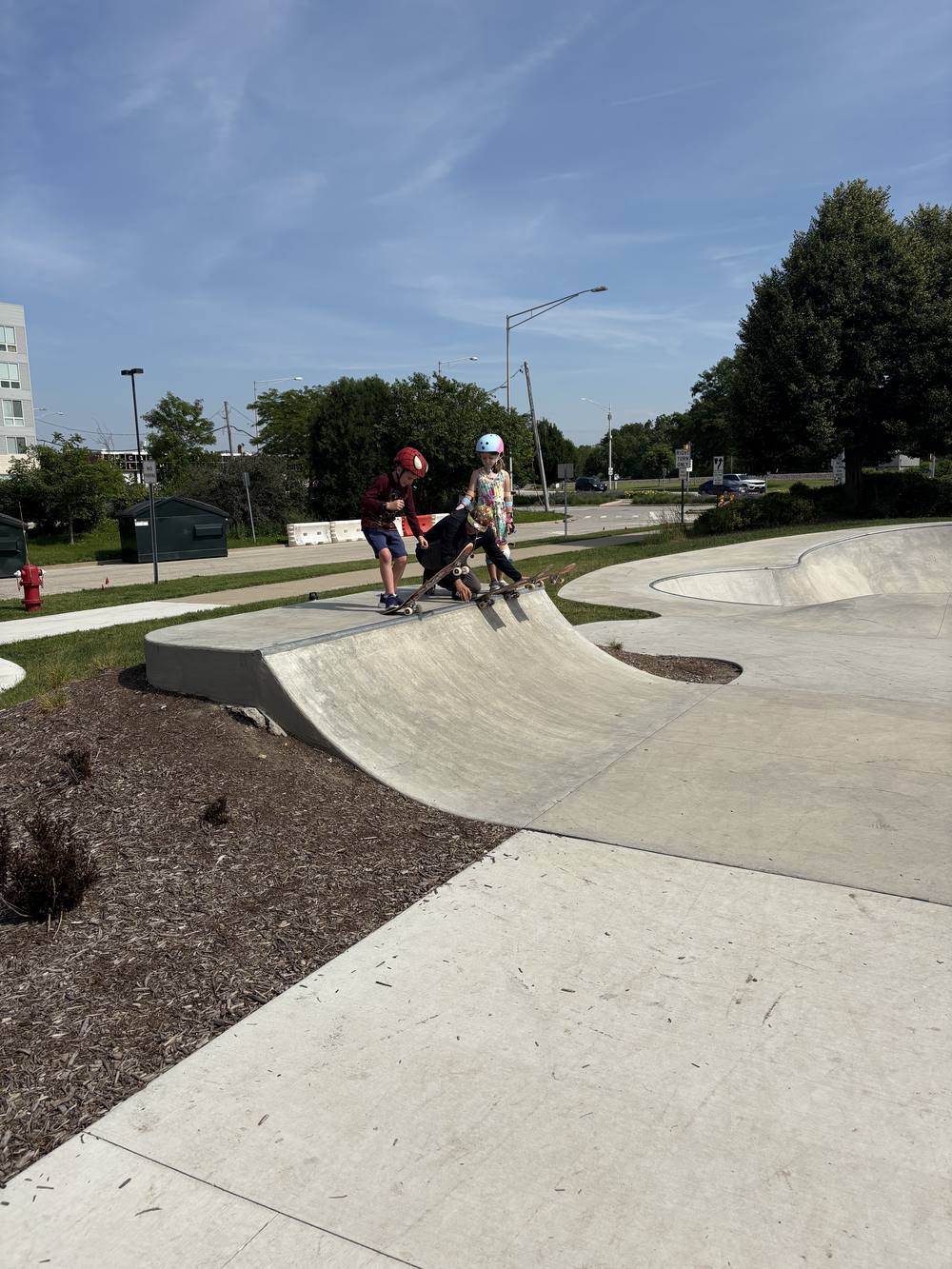 Coaches and young skaters practicing in the bowl at Recreation Park skate park in Arlington Heights