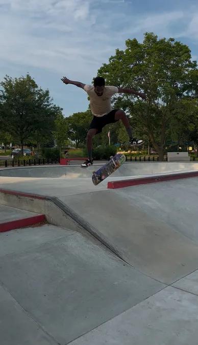Coach Antonio Whisenton catching air on his skateboard in a bowl