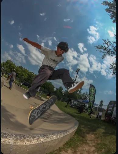 Coach Diya Ayoub performing a skateboard trick on a ramp