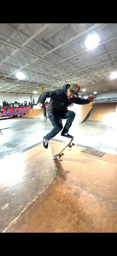 Coach Sebastian “Seabass” Aleksov skateboarding at an indoor skatepark