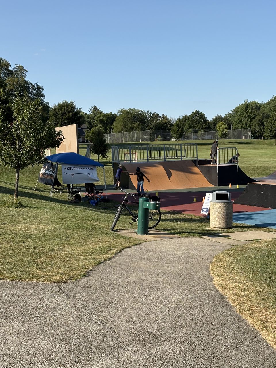 Skate Lessons Chicago tent and gear set up beside the ramps at Newton Park in Glen Ellyn