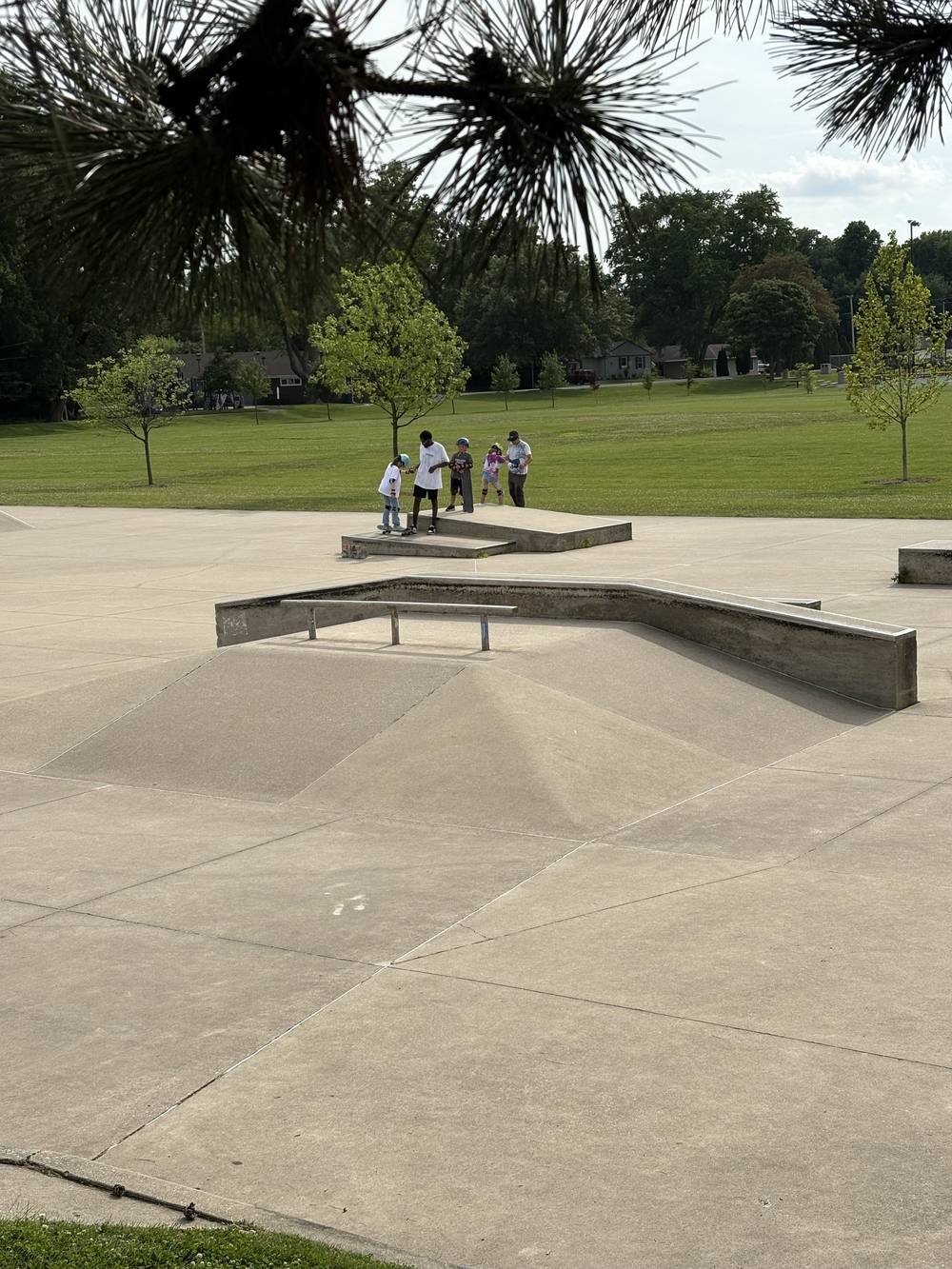 Skate Lessons Chicago coach and young skaters practicing at Roselle Skate Park