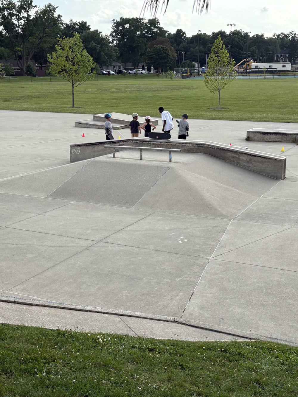 A group skateboarding lesson in session on the ramps at Roselle Skate Park